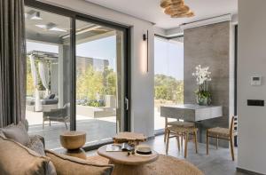 a living room with a couch and a table at Aegiali Luxury Villa in Kaligata