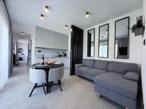 a living room with a couch and a table at ELEM apartments in Liptovský Mikuláš