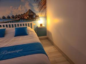 a bedroom with a bed with a mural of a resort at L'escale Romanesque in Ozeville