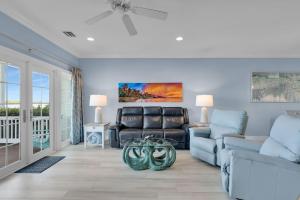 a living room with a couch and a table at Waterfront luxury Villa 59 with sunset views and boat slip townhouse in Marathon