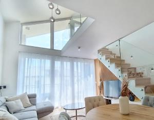 a living room with a couch and a table at Blackbird Boutique Apartment in Keszthely