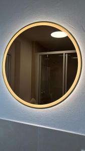 a circular mirror on a wall in a bathroom at Bio-Nestlein Apartments in Löffingen +26 photos