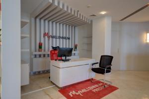 an office with two chairs and a desk with a computer at Millennium Lakeview Hotel in Dubai