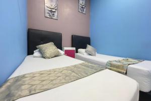 Postel nebo postele na pokoji v ubytování Hotel 3Winz, Chow Kit Hospital Kuala Lumpur