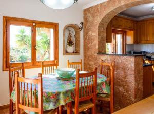 a kitchen and dining room with a table and chairs at Villa Can Cardona Sea views Perfect 4 families in Sant Rafael de Sa Creu