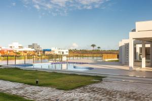 a swimming pool in the middle of a building at Modern and sophisticated apartments near the beach in Maraú – VLL in Marau