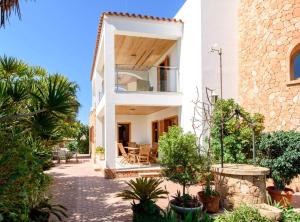 an external view of a house with trees and plants at Villa Can Cardona Sea views Perfect 4 families in Sant Rafael de Sa Creu