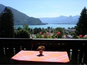 a table on a balcony with a view of a lake at Haus Stadler in Sankt Gilgen