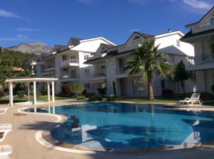 a large swimming pool in front of a building at Attolos Residence in Kemer