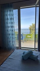 a bedroom with a bed and a view of a balcony at Filoxenia Residence in Palasë +22 photos