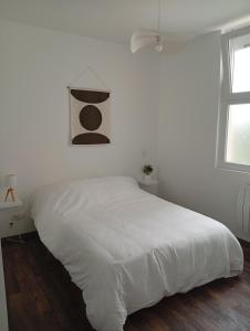 Ένα ή περισσότερα κρεβάτια σε δωμάτιο στο Appartement avec Jardin privé