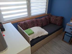a futon couch in a room with a window at Pokoje do wynajęcia in Michałowo