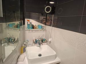 a bathroom with a sink and a mirror at Pokoje do wynajęcia in Michałowo