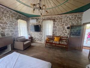 a living room with a couch and a tv at Myra in Himare