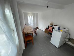 a kitchen with a table and a white refrigerator at Myra in Himare