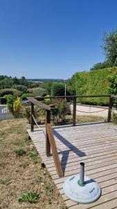 a wooden boardwalk with a picnic table on it at Le Jardin des Vignes 1 in Montsoreau