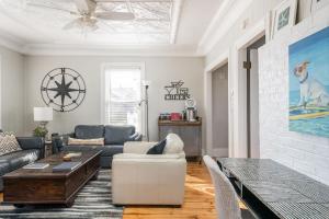 a living room with a couch and a table at Arlies Digs One Block To Willard Beach in South Portland