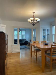 a dining room with a wooden table and chairs at Beautiful West End Apartment in Portland +14 photos