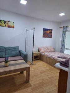 a living room with a bed and a couch at Villa Sun & Sea in Constanţa