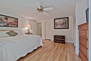 a bedroom with a bed and a ceiling fan at Back Cove - Large Sunny 2 Bedroom Condo in Portland