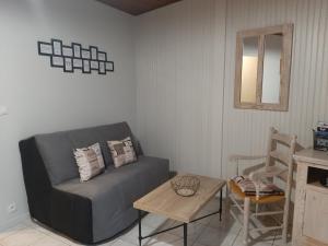 a living room with a couch and a table at Gîtes plouraboué "Lou Chai" in Navailles-Angos