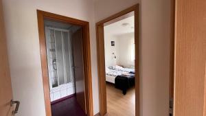 a room with a bedroom with a bed and a mirror at Grund í Grundarfirði Economy Guesthouse in Grundarfjordur