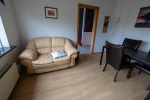 a living room with a couch and a table at Grund í Grundarfirði Economy Guesthouse in Grundarfjordur