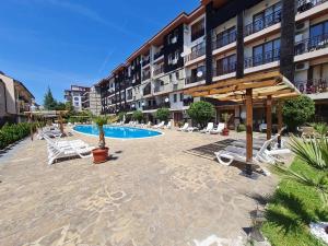 a resort with a pool and chairs and a hotel at MitProt Panorama Bay 2 Studio 93 in Sveti Vlas