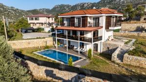 a villa with a swimming pool and a house at Villa Nirvana Selimiye Daily Weekly Rentals in Marmaris