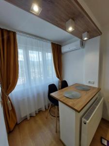 a kitchen with a table and chairs in a room at ONYX - Vision Aparthotel in Braşov