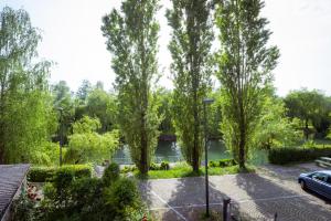 a view of a park with trees and a river at Riverview Residence - with parking in Ljubljana +20 photos