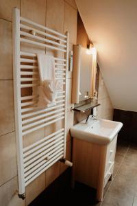 a small bathroom with a sink and a mirror at TOTO's apartment in Gheorgheni