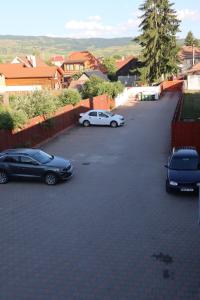a group of cars parked in a parking lot at TOTO's apartment in Gheorgheni