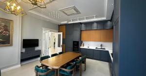 a dining room with a wooden table and chairs at Buzovna Private Seaside Villa in Baku