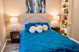 a bedroom with a blue bed with two pillows at Katy Hideaway - Charming 3 BDR in Katy