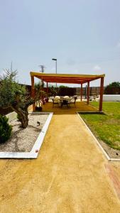 a pavilion with tables and chairs in a park at Villa Salinas Beach Home Natural Park in La Manga del Mar Menor +50 photos