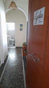a bathroom with a door with a sign on it at Lydia Home in Kavala +24 photos