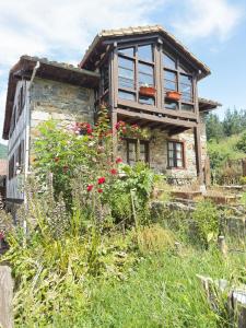 an old house with a window on top of it at Explora Picos de Europa in Cosgaya