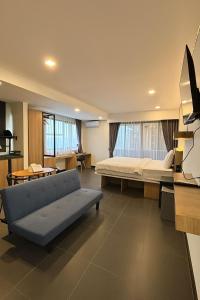 a living room with a couch and a bed at Alzeto Coliving in Legian +27 photos