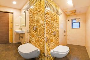 a bathroom with a toilet and a shower and a sink at FabHotel Kzar Select - Nr US Consulate in Kolkata