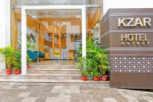 a hotel with potted plants in front of a building at FabHotel Kzar Select - Nr US Consulate in Kolkata