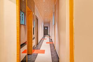 a hallway with orange and white floors and a long corridor at FabHotel Kzar Select - Nr US Consulate in Kolkata