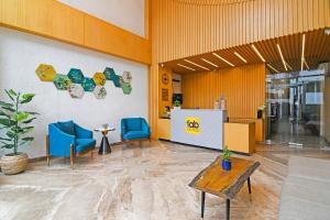 a lobby with two blue chairs and a table at FabHotel Kzar Select - Nr US Consulate in Kolkata