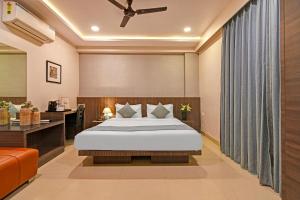 a hotel room with a bed and a desk at FabHotel Kzar Select - Nr US Consulate in Kolkata