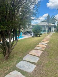 a stepping stone path in front of a building at Casa Amendoeiras in Lagoa Santa