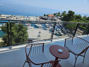 a balcony with two chairs and a table and a view at Amadria Park Grand Hotel 4 Opatijska Cvijeta in Opatija