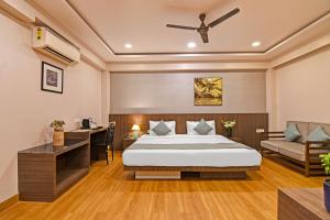 a hotel room with a bed and a desk at FabHotel Kzar Select - Nr US Consulate in Kolkata