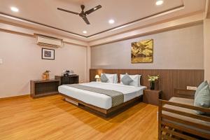 a bedroom with a bed and a ceiling fan at FabHotel Kzar Select - Nr US Consulate in Kolkata
