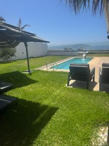 a park with a bench and a swimming pool at Villa Continental 4bedrooms in Tangier