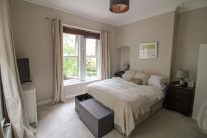 a bedroom with a bed and a window at Chertsey Mount Townhouse, Carlisle in Carlisle